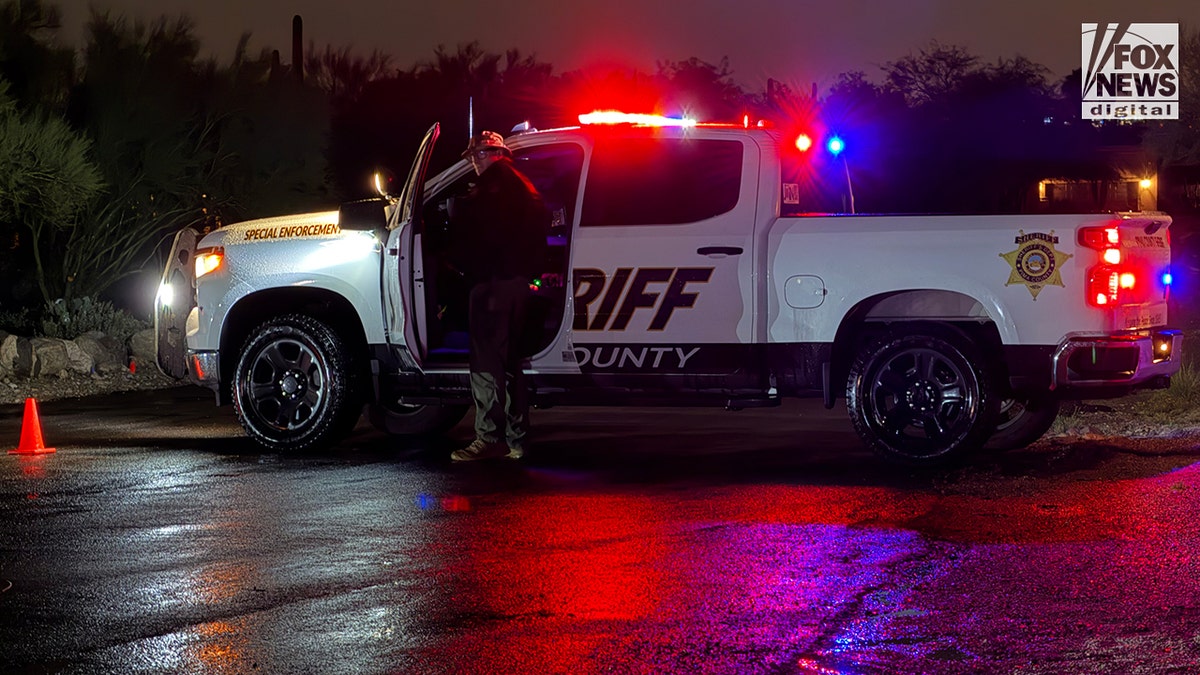 A Pima County Sheriff's deputy standing during a law enforcement operation at an intersection in Tucson, Arizona.