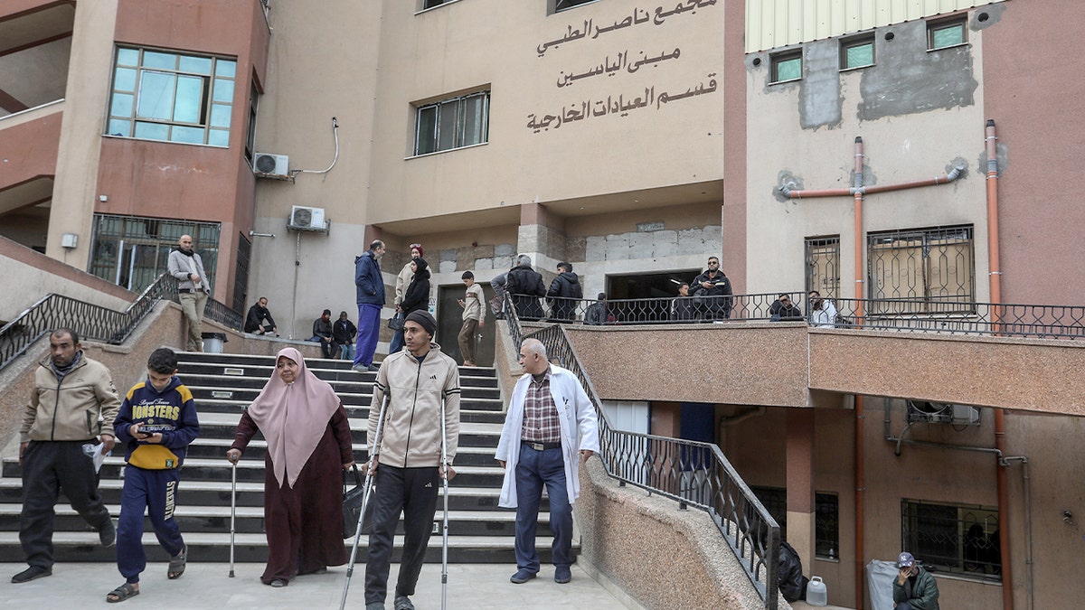 Injured Palestinians receive care inside a crowded hospital orthopaedic ward amid shortages of medical supplies.