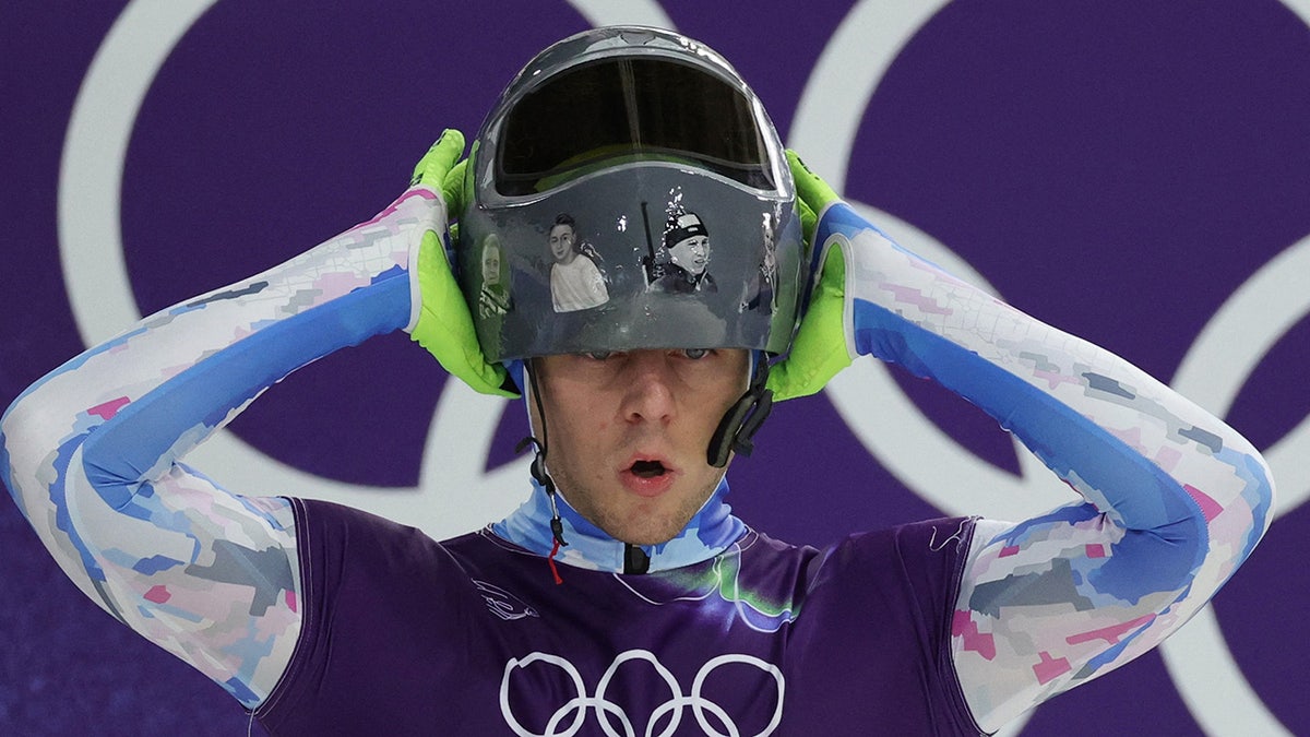 Vladyslav Heraskevych puts the helmet on