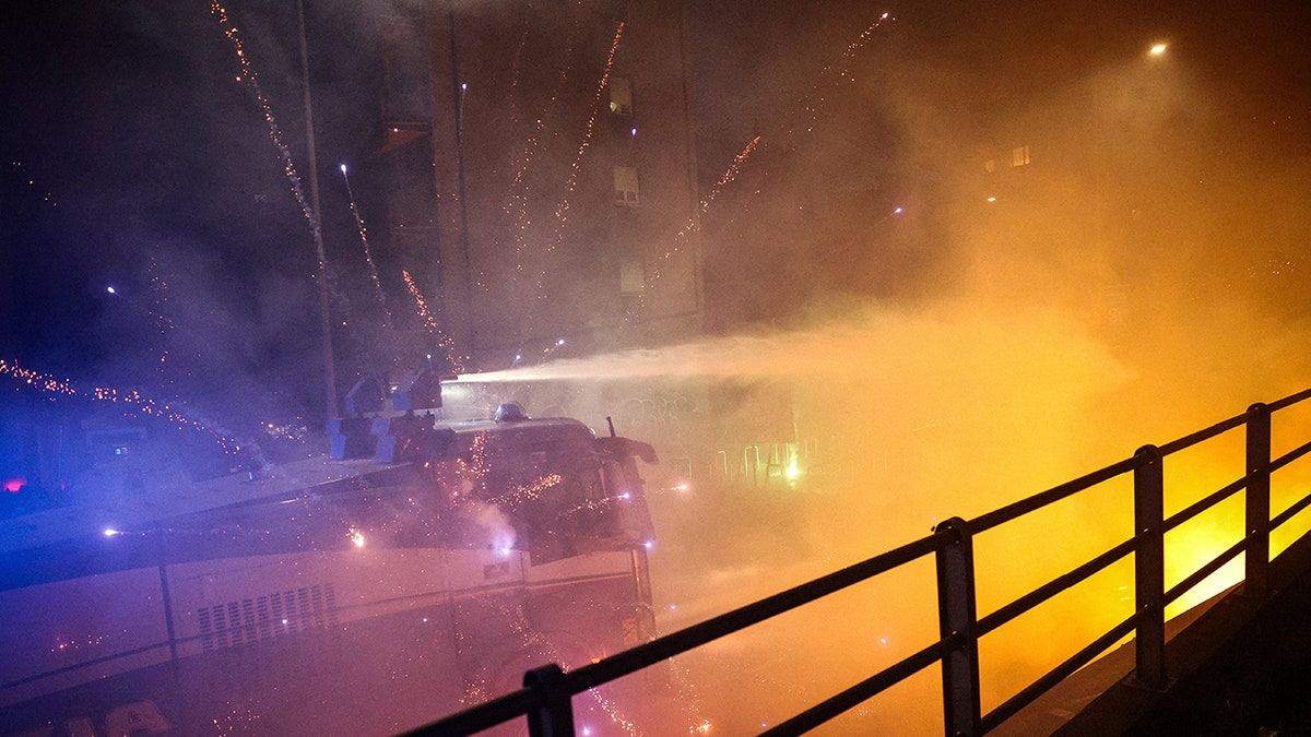 Fireworks explode near law enforcement personnel in Italy