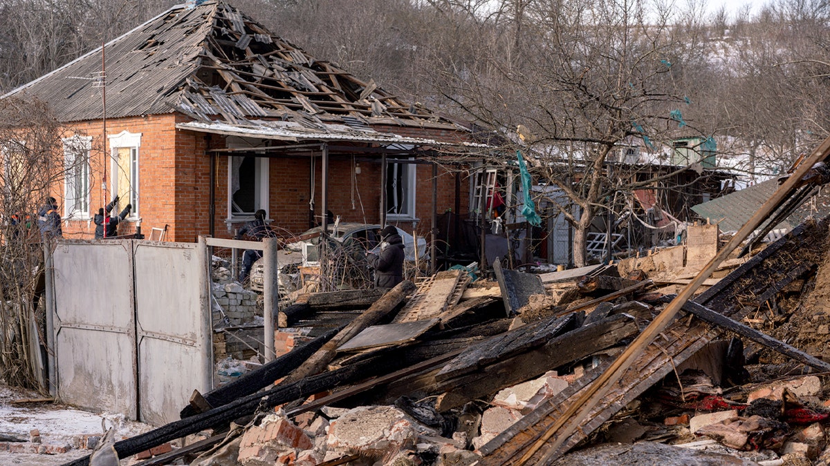 Destroyed residential building and scattered debris fill a neighborhood following an overnight drone strike.