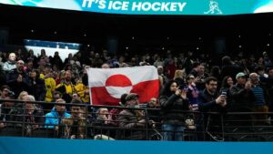 Olympic hockey fans raise Greenland's flag during USA's dominant win over Denmark, sparking viral reaction