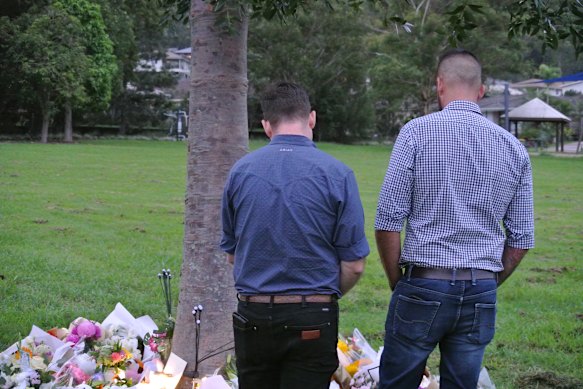 Logan Mayor John Raven (left) at the memorial on Friday.