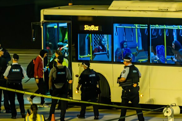 The team board a waiting bus at Sydney airport.