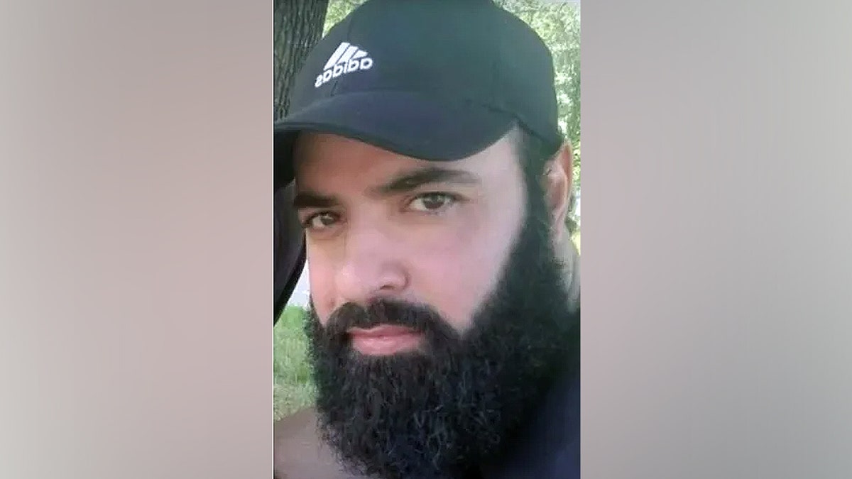 Ayman Mohamad Ghazali wearing an Adidas hat