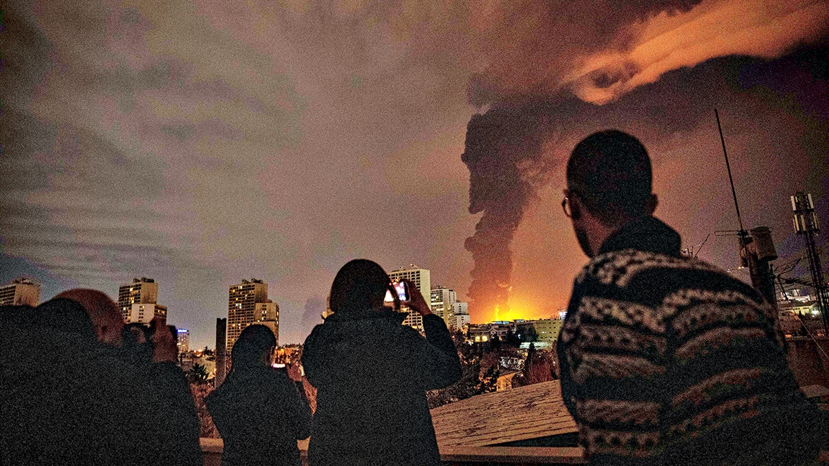 flames and smoke rise from an oil storage facility hit in strikes