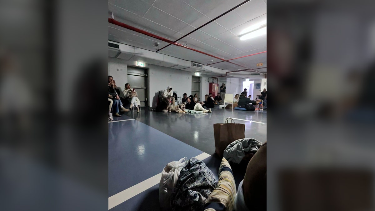 People sit inside bomb shelter in Tel Aviv