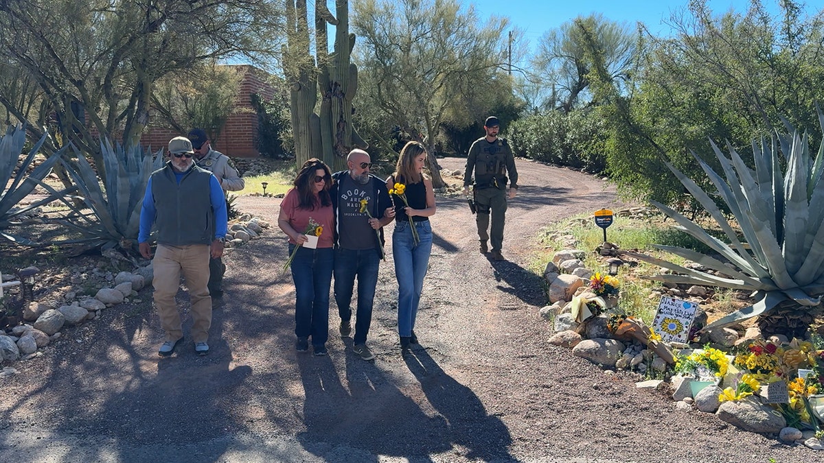 The Guthrie family lays flowers at Nancy Guthrie's home