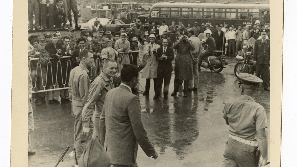 Neil Armstrong David Scott waving to service members
