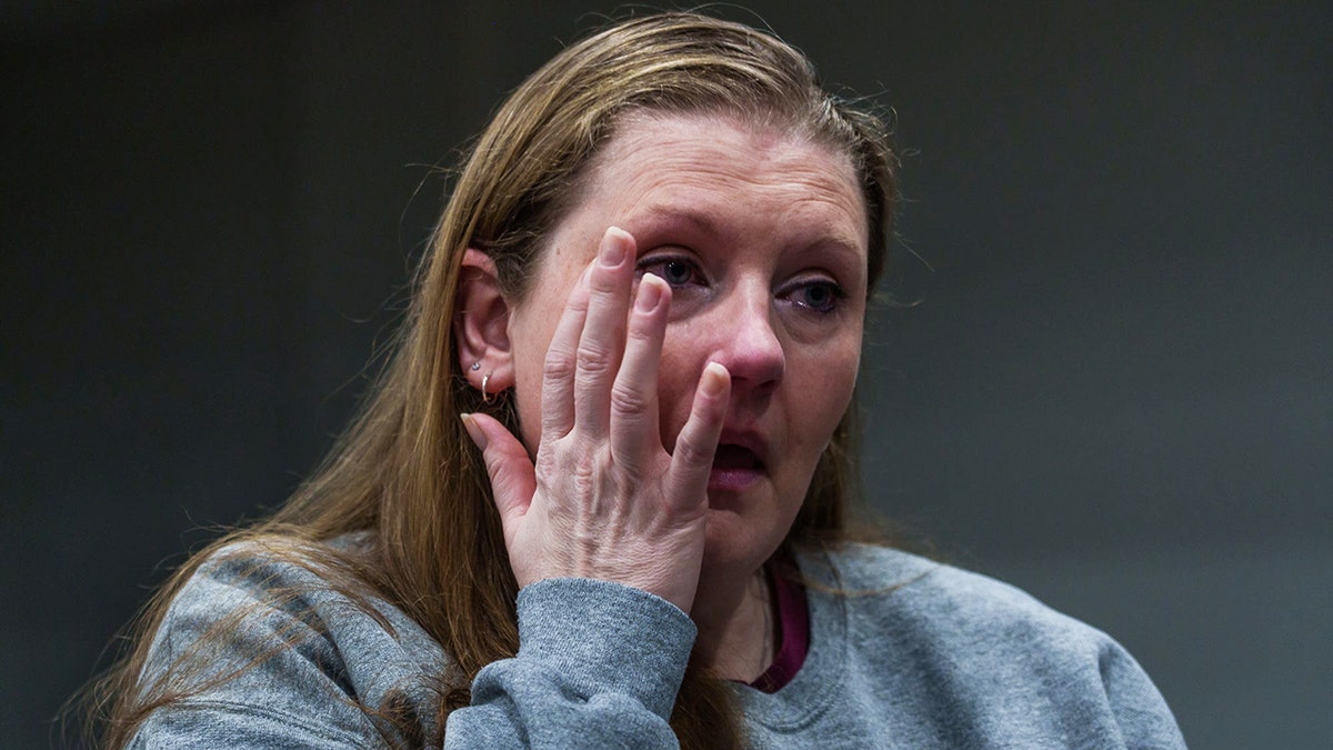 Sarah Pender wiping her eyes.