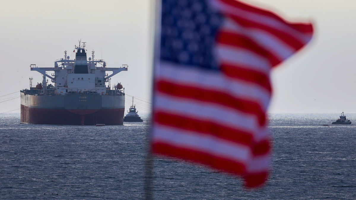 An oil tanker is seen off the coast of California with an American flag flying nearby.