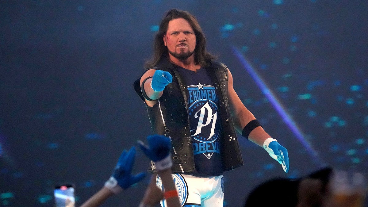 AJ Styles points to the crowd