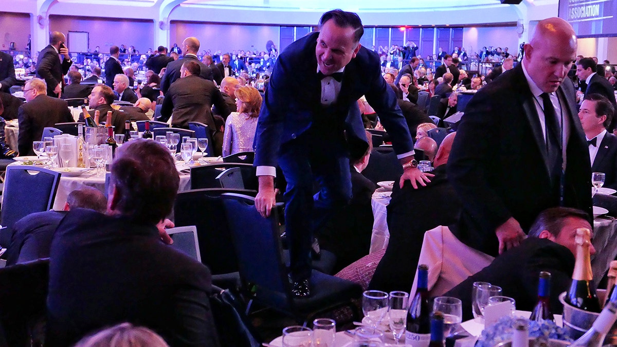 White House Deputy Chief of Staff Dan Scavino jumping over a chair at an event