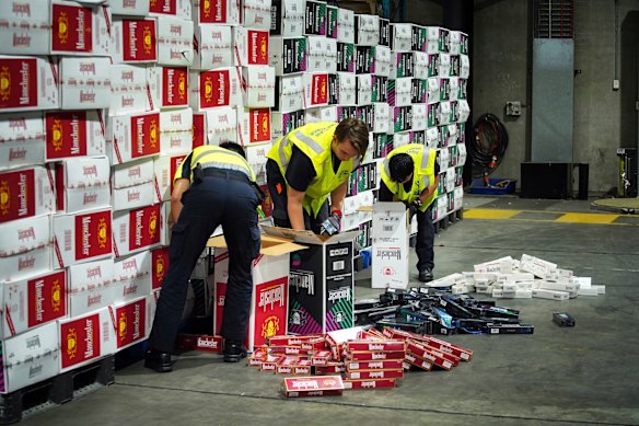 The Australian Border Force officers check illegal cigarette imports found in shipping containers in Melbourne.