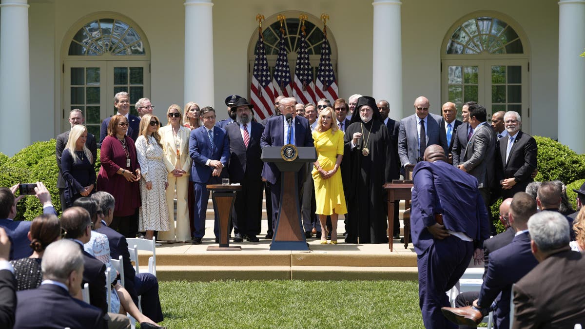 President Donald Trump calling people to the podium in the White House Rose Garden