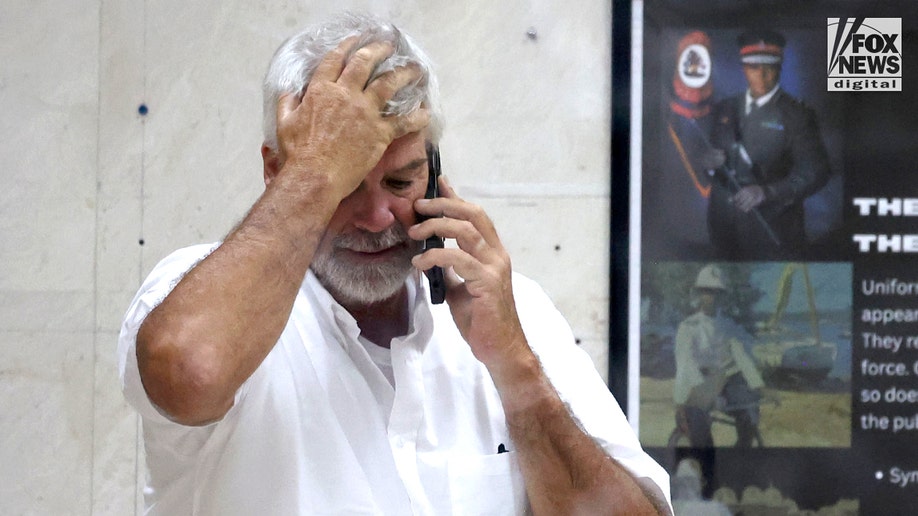 Brian Hooker leaves police station in The Bahamas, with lawyer