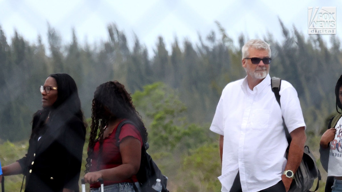 Brian Hooker and lawyer boarding a plane in The Bahamas