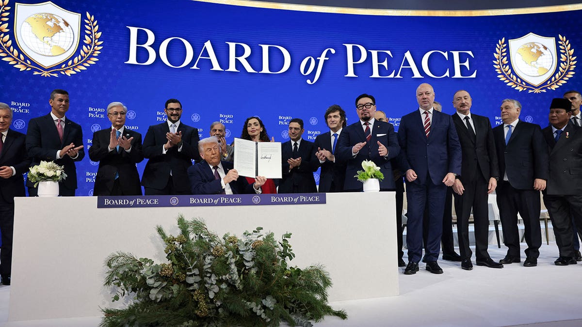 U.S. President Donald Trump speaking at a podium during the Board of Peace announcement in Davos Switzerland