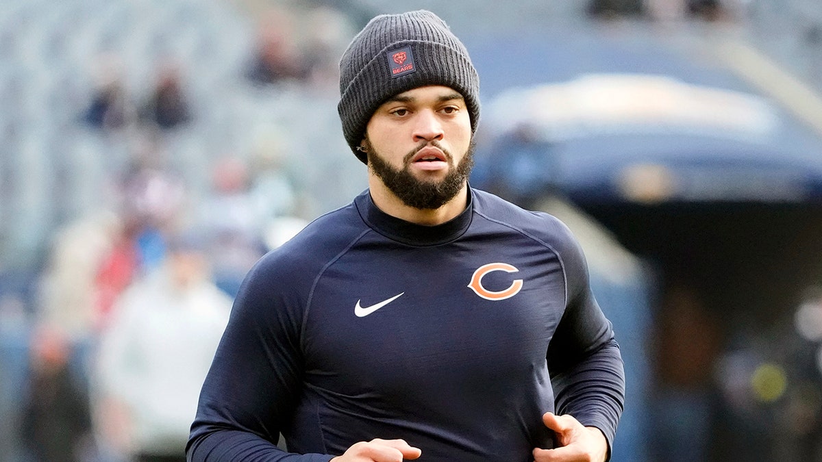 Chicago Bears quarterback Caleb Williams warming up on the field at Soldier Field.