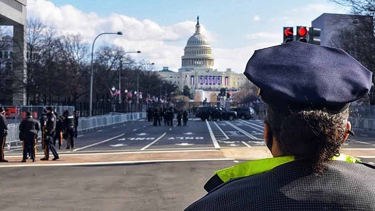 Police officers standing near the U.S. Capitol building in Washington, D.C.