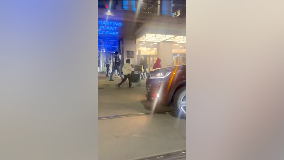 Dozens of teens run through downtown Detroit during a chaotic