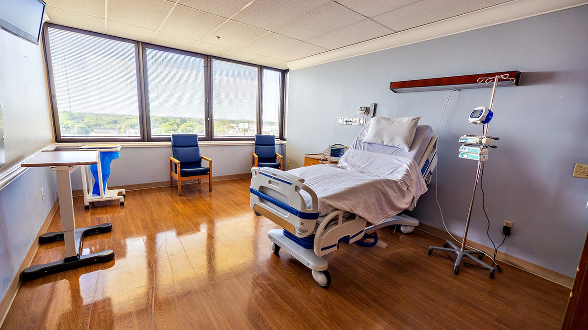 an empty hospital bed and room