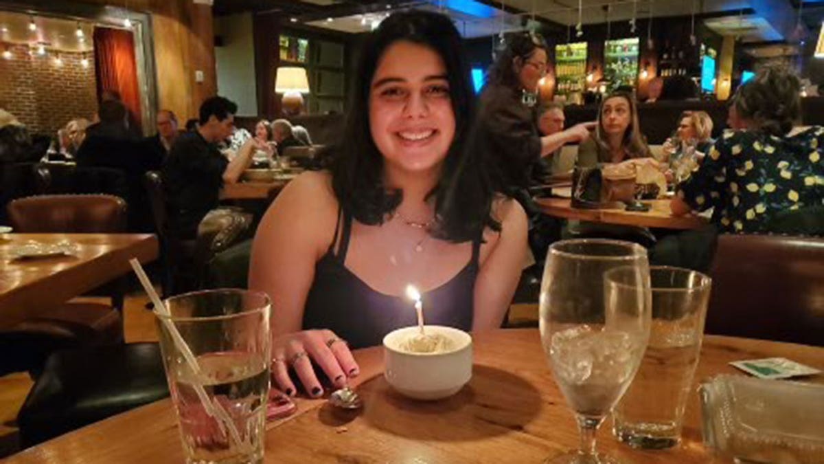 Katie Abraham smiling in a family photo