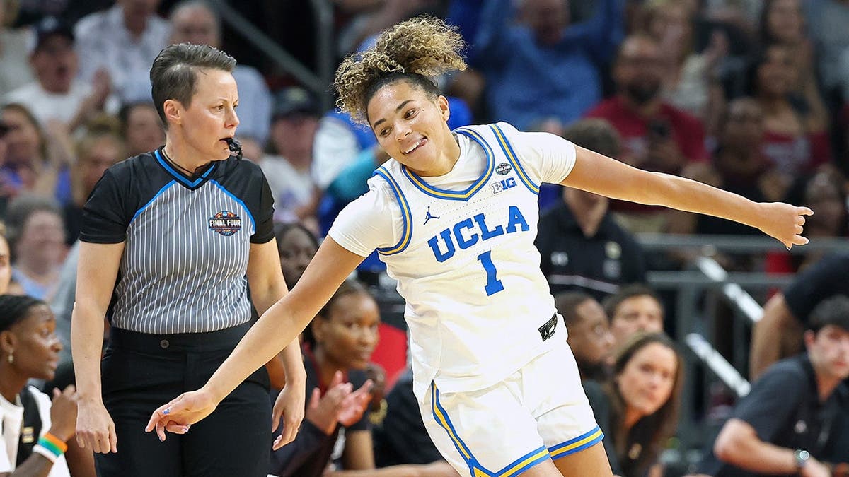 Kiki Rice of UCLA Bruins reacts after making a three-point basket in basketball game.