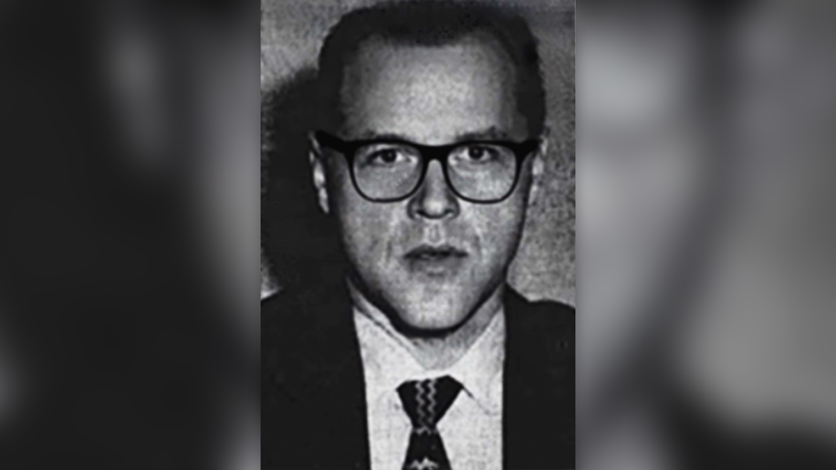 A black and white image of Marvin Merrill in 1969 shows him wearing glasses and a suit