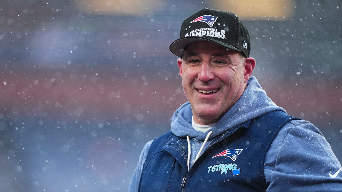 New England Patriots head coach Mike Vrabel celebrating on the field at Empower Field At Mile High