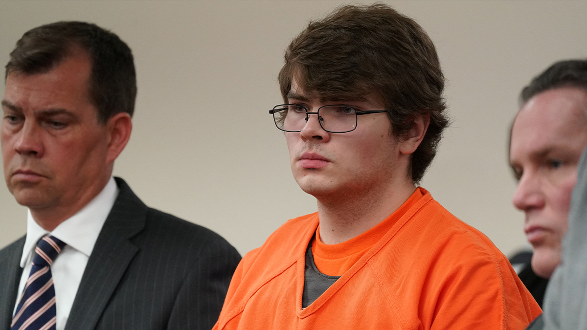 Convicted mass shooter Payton Gendron listens in court at his sentencing, while wearing an orange jail jumpsuit and thin-framed glasses