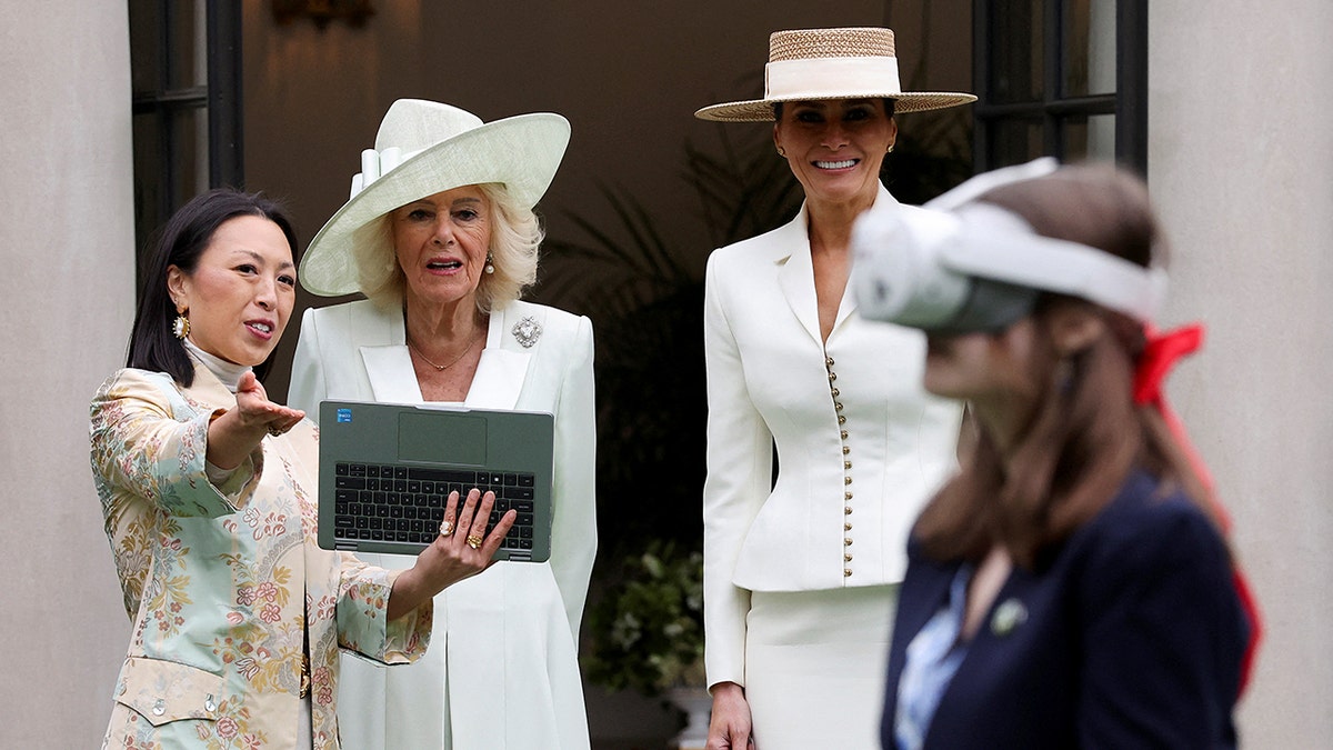 First lady Melania Trump and Queen Camilla watching a student using virtual reality goggles