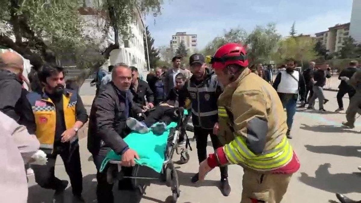 An injured person being carried to an ambulance after a school shooting in Kahramanmaras, Turkey