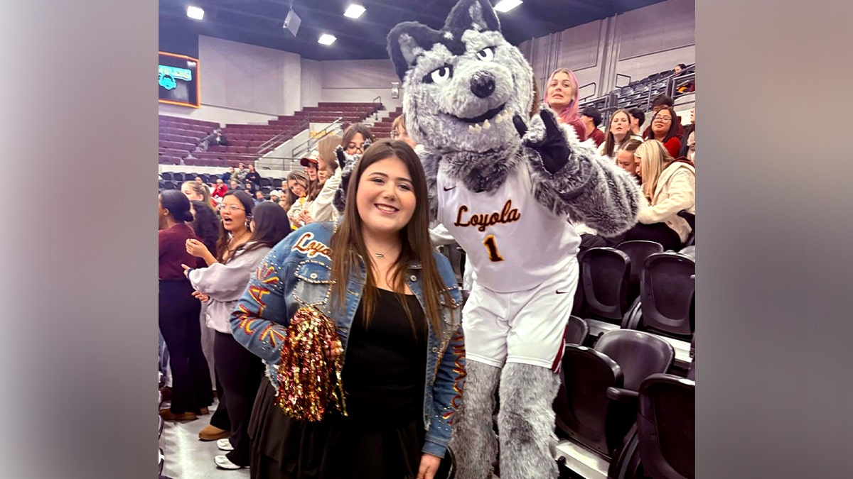 Loyola University Chicago student Sheridan Gorman posing with the school mascot on campus