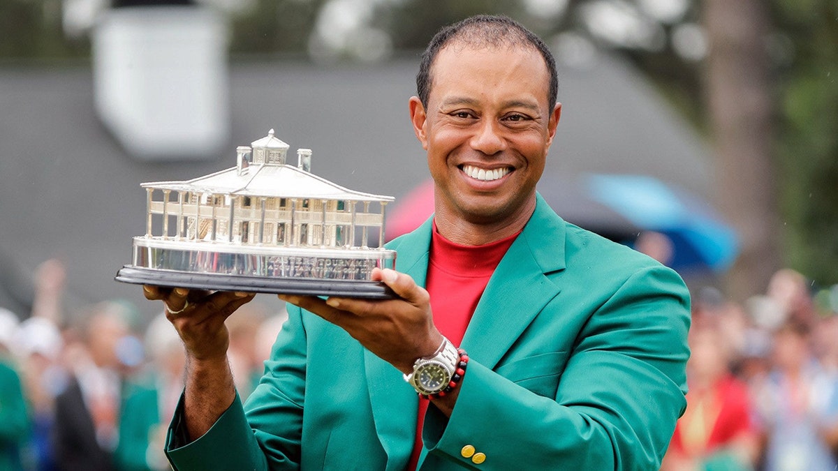Tiger Woods celebrating during trophy presentation at Augusta National Golf Club