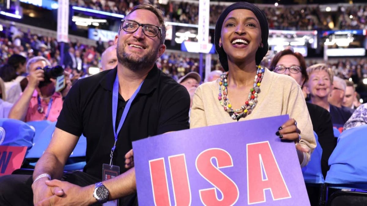 Rep. Ilhan Omar sitting with husband Tim Mynett at the United Center in Chicago
