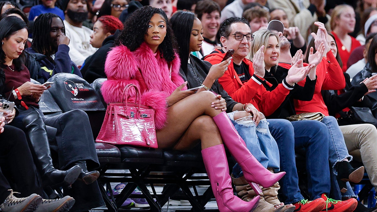 Chicago Sky forward Angel Reese sitting courtside at United Center watching NBA game