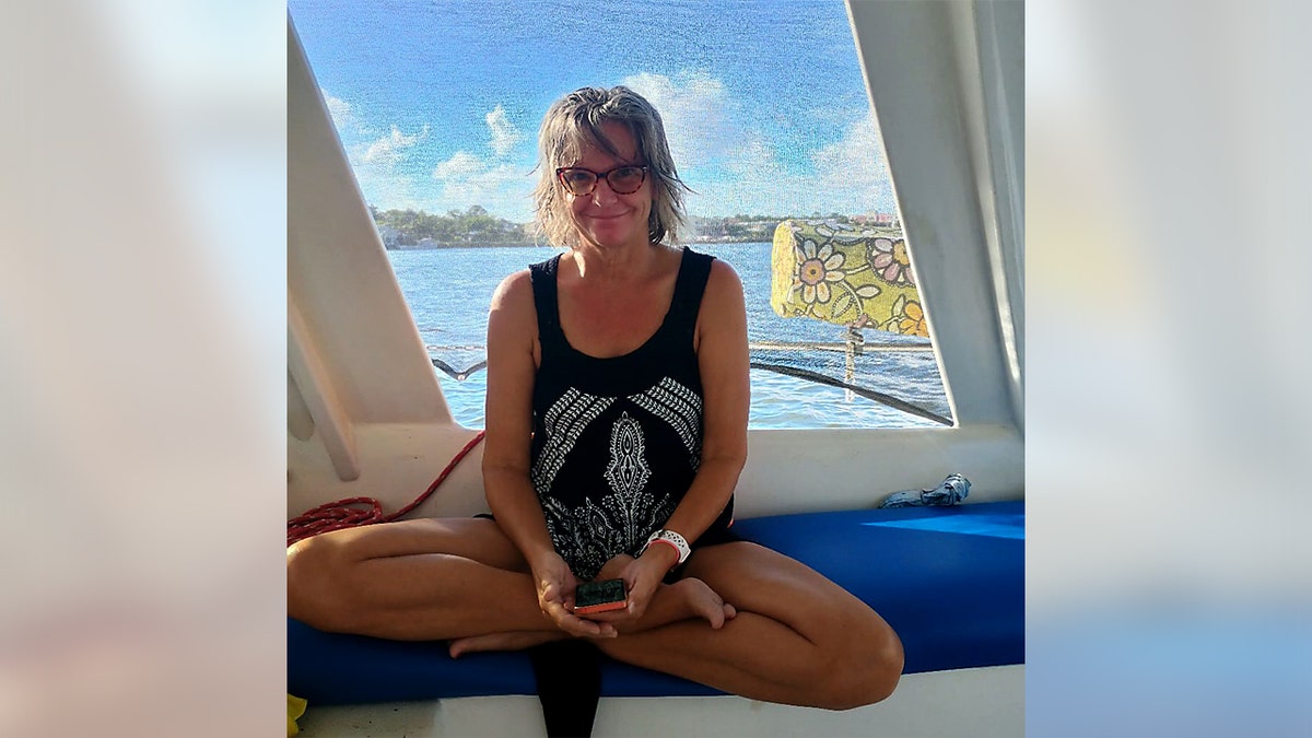 Lynette Hooker standing on a boat deck in the Bahamas