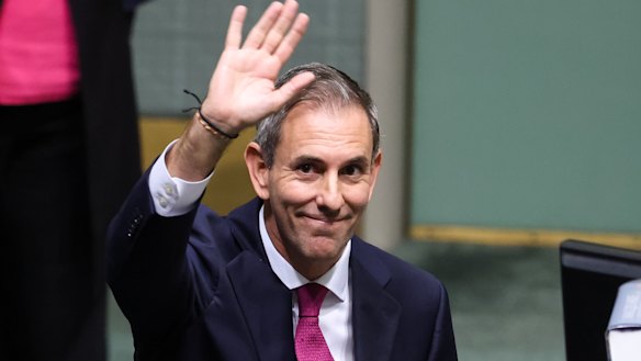 Treasurer Dr Jim Chalmers waves towards people in the public galleries after the Budget speech.