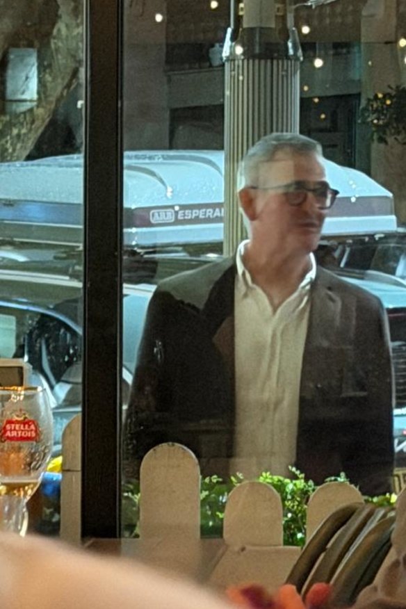 Brad Banducci watching the Origin opener through a pub window in Sydney on Wednesday evening.