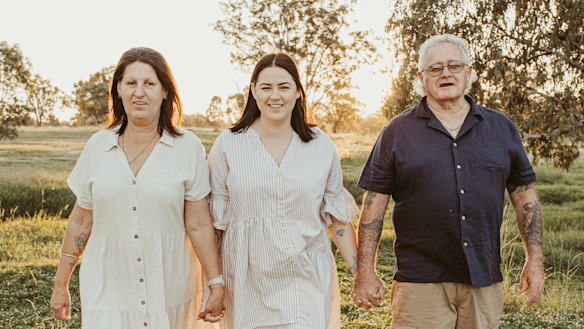 Molly Ticehurst (centre) with her parents.