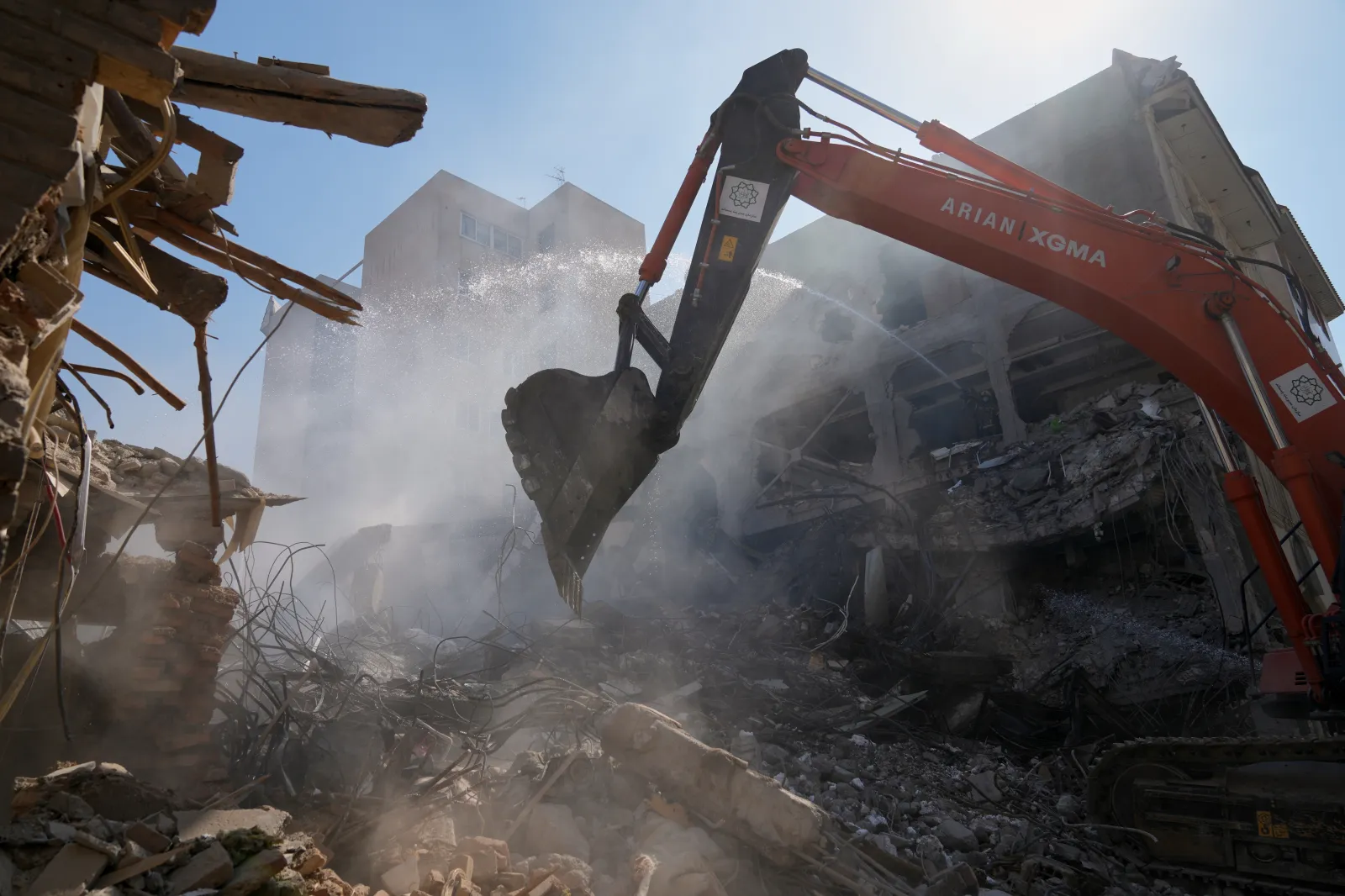 An excavator removes rubble at the site of a strike that, according to a security official at the scene, destroyed half of the Khorasaniha Synagogue and nearby residential buildings in Tehran, Iran, on April 7, 2026. (AP Photo/Francisco Seco)