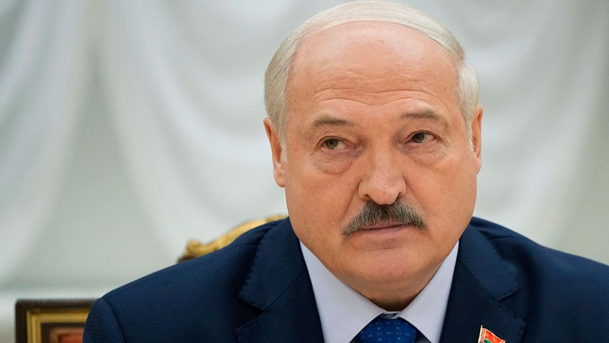 Belarusian President Alexander Lukashenko listening during a meeting with foreign correspondents