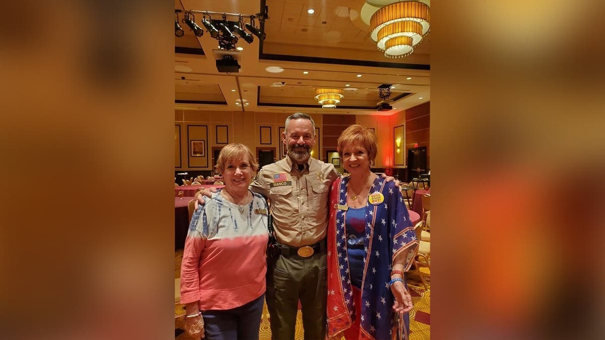 Karen standing next to a man and a woman