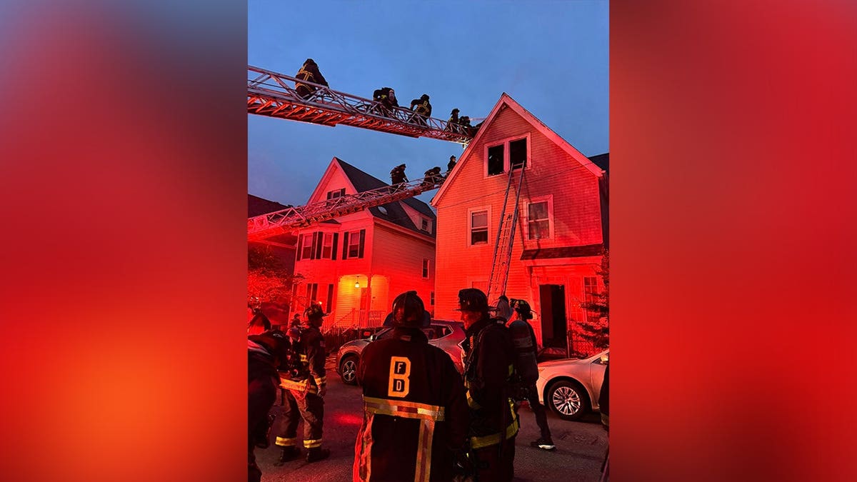 Firefighters battle a three-alarm house fire in Dorchester, Massachusetts