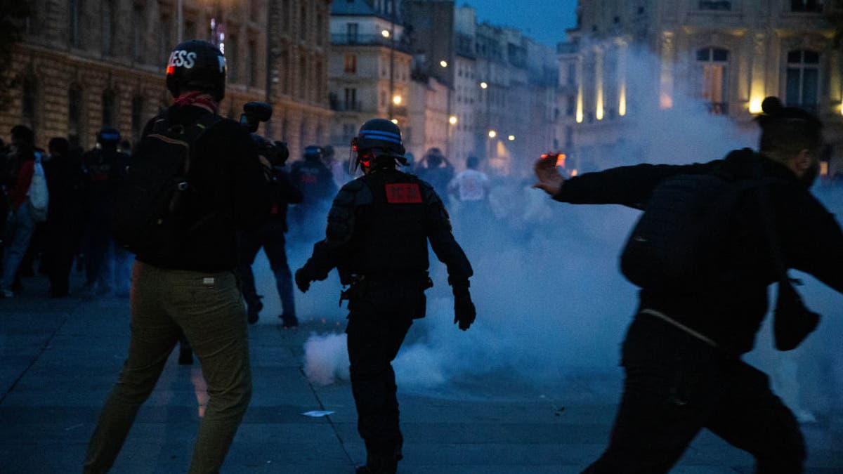 French riot police using tear gas to disperse demonstrators at a pro-Palestinian rally in Paris