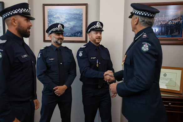 From left: Senior constables Jared Eames and Michael Gaetano and Sergeant Brad Dettman with Chief Commissioner Mike Bush.