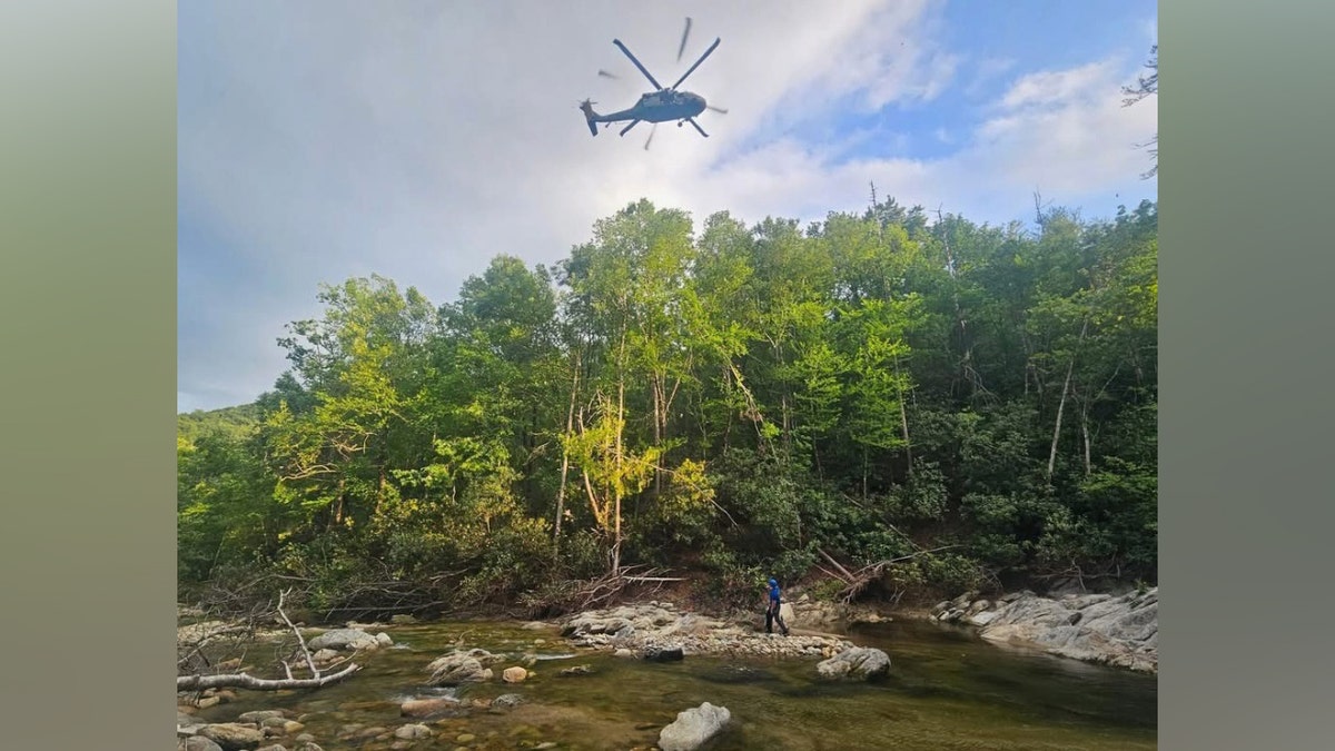 A Black Hawk helicopter flying over wooded area in Avery County North Carolina