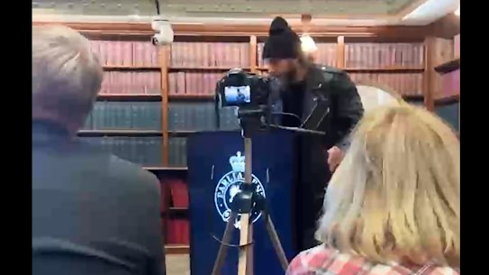 Mobile phone footage shows neo-Nazi Joel Davis speaking at an event in the Jubilee Room at NSW Parliament in May 2025. 