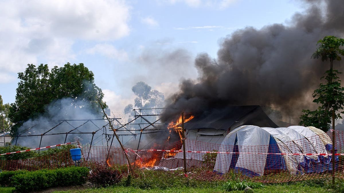 Flames and smoke rise from an Ebola treatment center in Rwampara, Congo